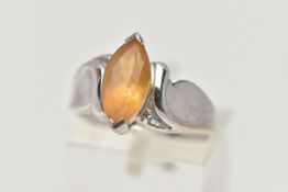 A 9CT WHITE GOLD TOPAZ RING, designed with a marquise cut yellow topaz, to scrolling shoulders and