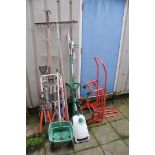 A QUANTITY OF GARDEN TOOLS to include a Coopers portable sprayer, telescopic tree lopper, rakes,