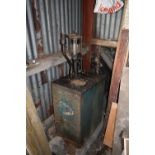 A VINTAGE ESSO BADGED OIL DISPENSER with working pump and site glass width 42cm depth 58cm height