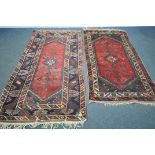 TWO SIMILAR PERSIAN KAZAK RUGS, made up of red and blue fields largest rug measurement 214cm x