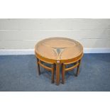 A MID CENTURY NATHAN TRINITY TEAK CIRCULAR COFFEE TABLE with a glass insert, with a matching set