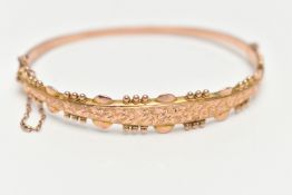 A 9CT GOLD HINGED BANGLE, with ivy leaf pattern and applied bead work surround, Sponsors mark 'S&P',
