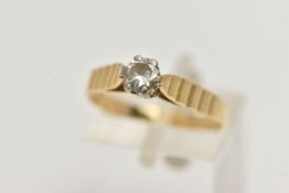 A YELLOW METAL SINGLE STONE DIAMOND RING, designed with a round brilliant cut diamond, in a six claw