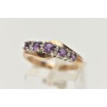 A 9CT GOLD AMETHYST AND DIAMOND RING, designed with a row of graduating circular cut amethyst,
