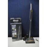 A SHARK WV361UK WANDVAC SYSTEM in original box with attachment and charger base (PAT pass and