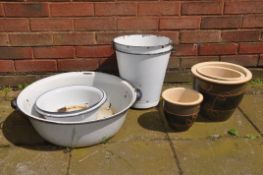 A SET OF THREE GLAZED PLANT POTS with leaf design, along with three circular enamel pots and two