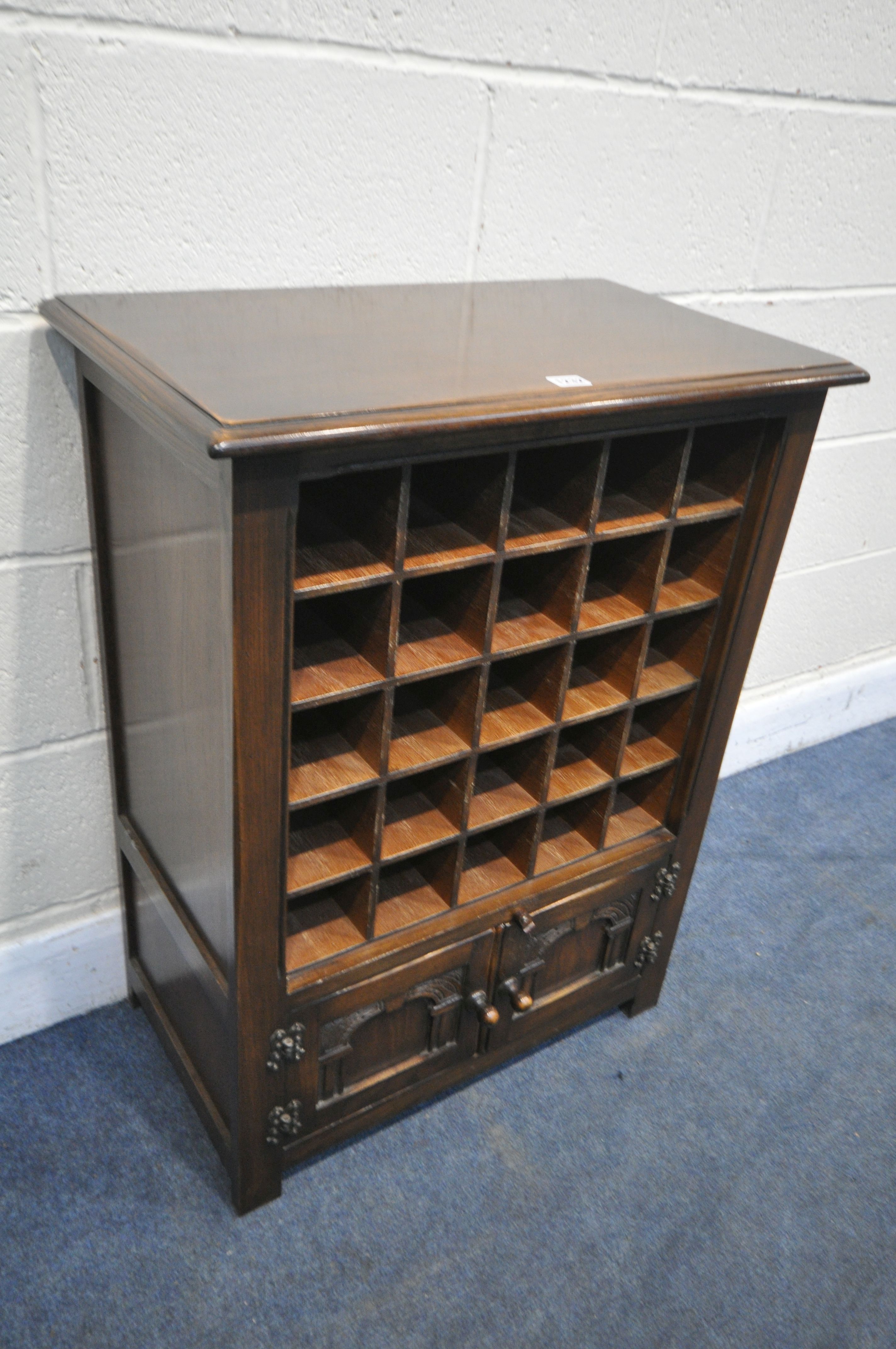 A BEVAN FUNNEL REPRODUX OAK 25 HOLE WINE CABINET, with double cupboard doors, width 66cm x depth