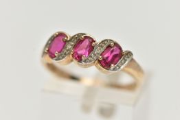 A 9CT GOLD GEM SET RING, three oval cut synthetic rubies accented with four round brilliant cut