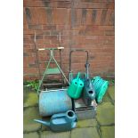 A SELECTION OF GARDEN ITEMS, to include a roller, two hose pipes and reels, three watering cans,