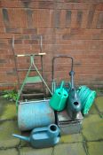 A SELECTION OF GARDEN ITEMS, to include a roller, two hose pipes and reels, three watering cans,