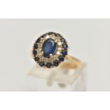 A YELLOW METAL SAPPHIRE AND DIAMOND CLUSTER RING, large oval cluster set with a central oval cut