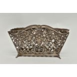 A WHITE METAL LETTER HOLDER, openwork lattice design with floral, foliage and cherub detail, stamped
