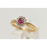 AN 18CT GOLD, RUBY AND DIAMOND CLUSTER RING, designed with an oval cut ruby, in a twelve claw