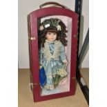 A COLLECTOR'S CHOICE PORCELAIN DOLL, in a protective leather carry case with a perspex front,