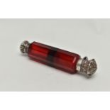 A LATE VICTORIAN DOUBLE ENDED RUBY GLASS SCENT FLASK WITH WHITE METAL MOUNTS, the flask of decagonal