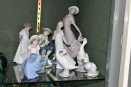 SEVEN NAO FIGURES AND A LLADRO DUCK, the tallest, a female figure in a flowing dress, measures 28.