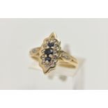 A YELLOW METAL SAPPHIRE AND DIAMOND RING, lozenge shape ring set with a row of three blue sapphires,