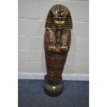 A REPRODUCTION WOODEN SINGLE DOOR CABINET, in the form of a Egyptian Sarcophagus Pharaoh mummy,
