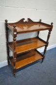 AN EDWARDIAN WALNUT THREE TIER BUFFET, united by turned supports, on ceramic casters, width 87cm x
