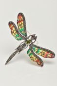 A WHITE METAL PLIQUE A JOUR BROOCH, in the form of a dragonfly, peridot and marcasite set body and