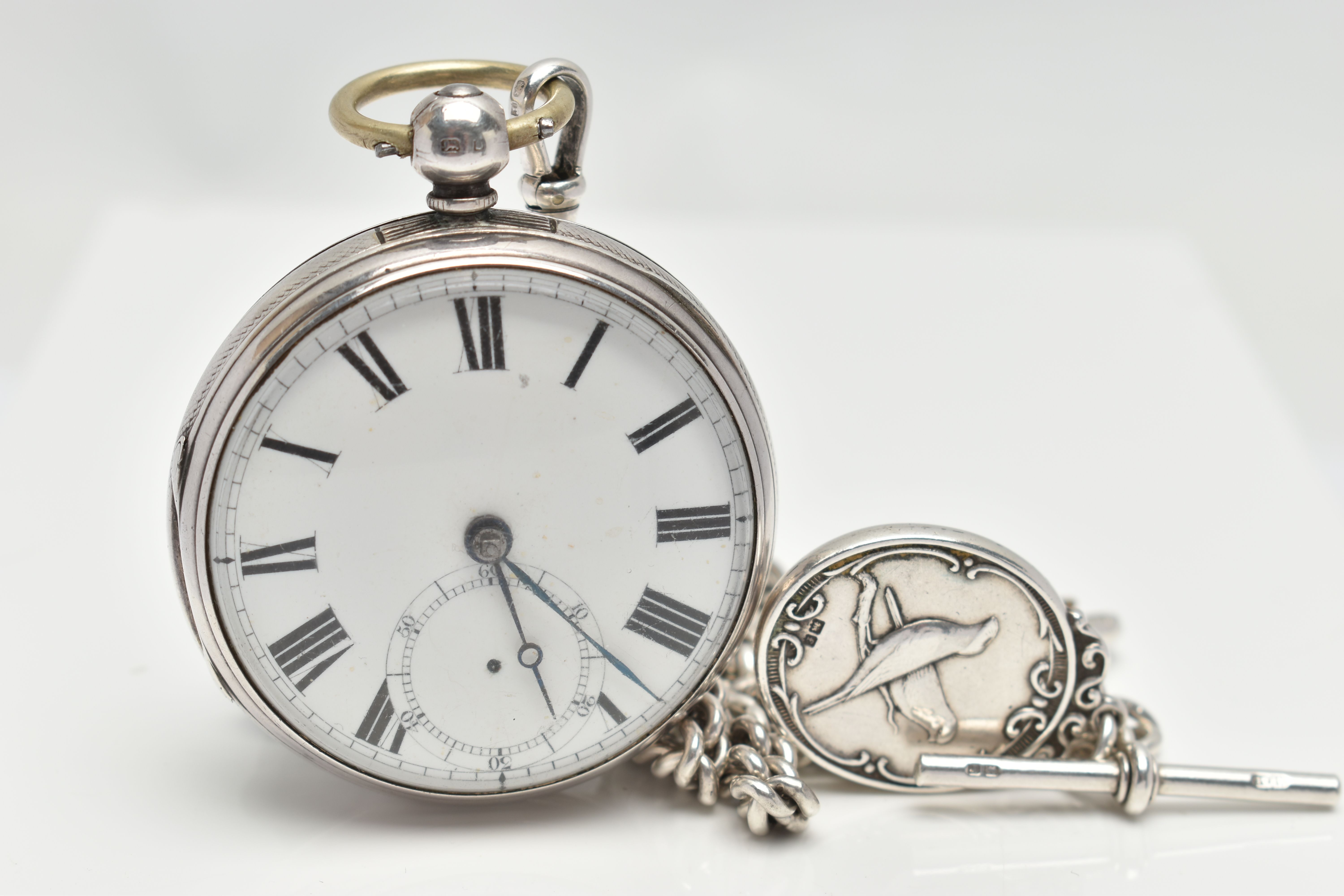 A LATE VICTORIAN SILVER OPEN FACE POCKET WATCH AND AN ALBERT CHAIN, key wound, round white dial,
