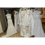 TWENTY-FOUR WEDDING DRESSES, ex shop stock, dresses may have dirty marks but are essentially new