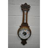 AN EDWARDIAN OAK ANEROID BAROMETER, height 101cm (condition:-cracked glass)