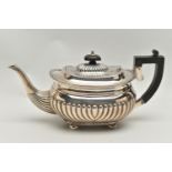 AN EDWARDIAN SILVER TEAPOT OF OVAL FORM, ebony fitments, gadrooned rim, reeded cover and body, on