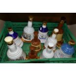 Eleven BELL'S WHISKY Porcelain Decanters, including commemorative editions, content sizes range from