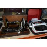 A VINTAGE SEWING MACHINE AND TYPEWRITER, comprising a cased hand cranked sewing machine, the case