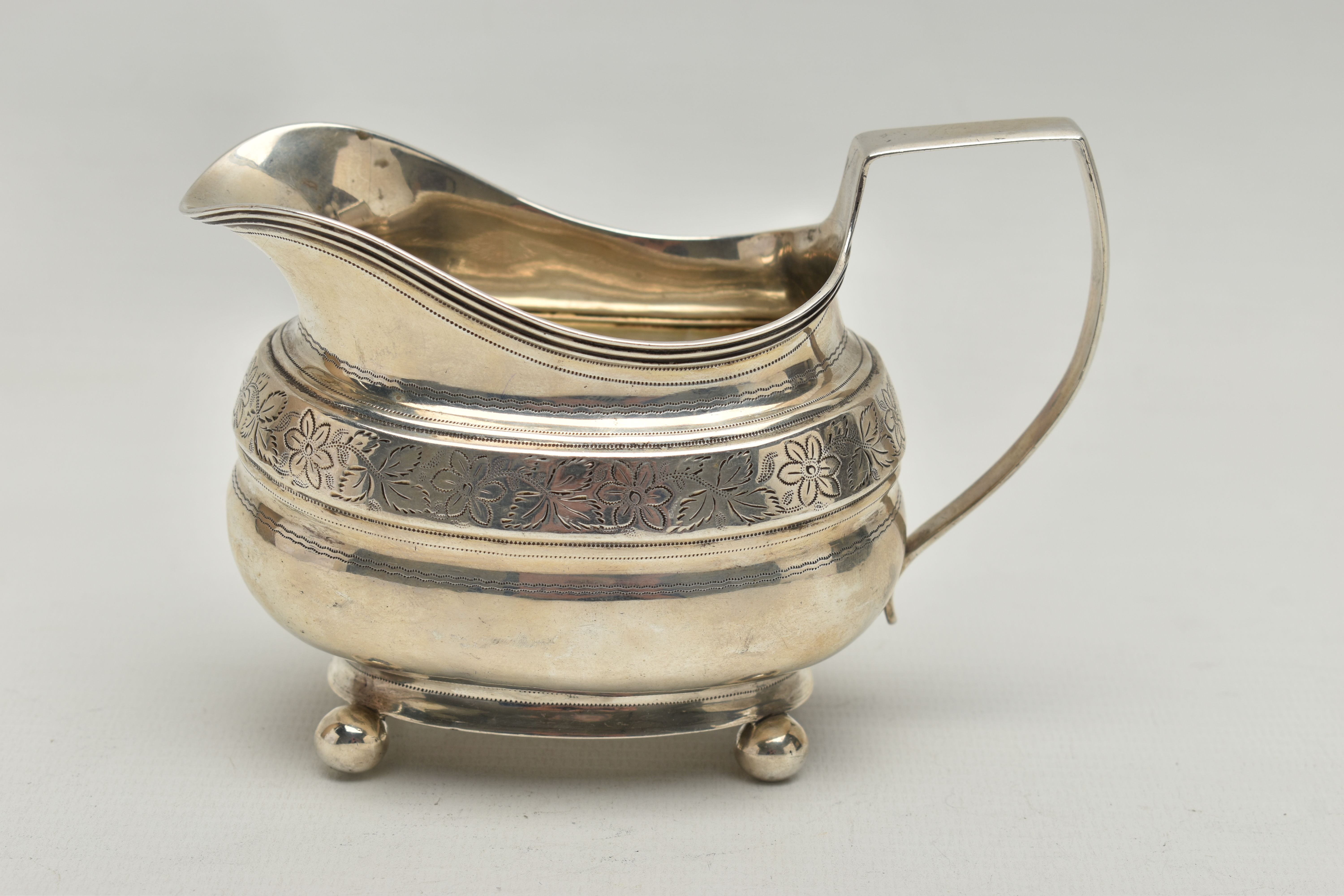 A GEORGE III SILVER HELMET SHAPED MILK JUG OF SHAPED OVAL FORM, angular handle, wriggle work and