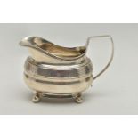 A GEORGE III SILVER HELMET SHAPED MILK JUG OF SHAPED OVAL FORM, angular handle, wriggle work and