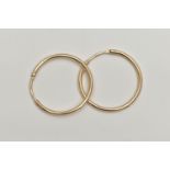 A PAIR OF YELLOW METAL HOOP EARRINGS, polished plain hoops, rubbed 14k stamp, approximate diameter