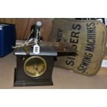 A BRASS SINGER SEWING MACHINE SIGN AND A BLICK TIME RECORDERS LIMITED 'UNIVERSAL' CLOCKING IN CLOCK,