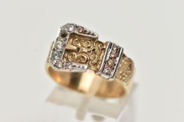 A 9CT GOLD BUCKLE RING, yellow belt with scrolling pattern, white metal buckle detail, set with