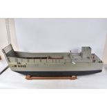 A MOTORISED WOODEN KIT BUILT MILITARY LANDING CRAFT MODEL, told by client has been out on water,