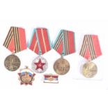 A SMALL PARCEL OF RUSSIAN MEDALS AND BADGES, four medals with pins attached ready for wearing and