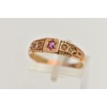 A LATE VICTORIAN 15CT GOLD RING, designed with a star set circular cut ruby, flanked with