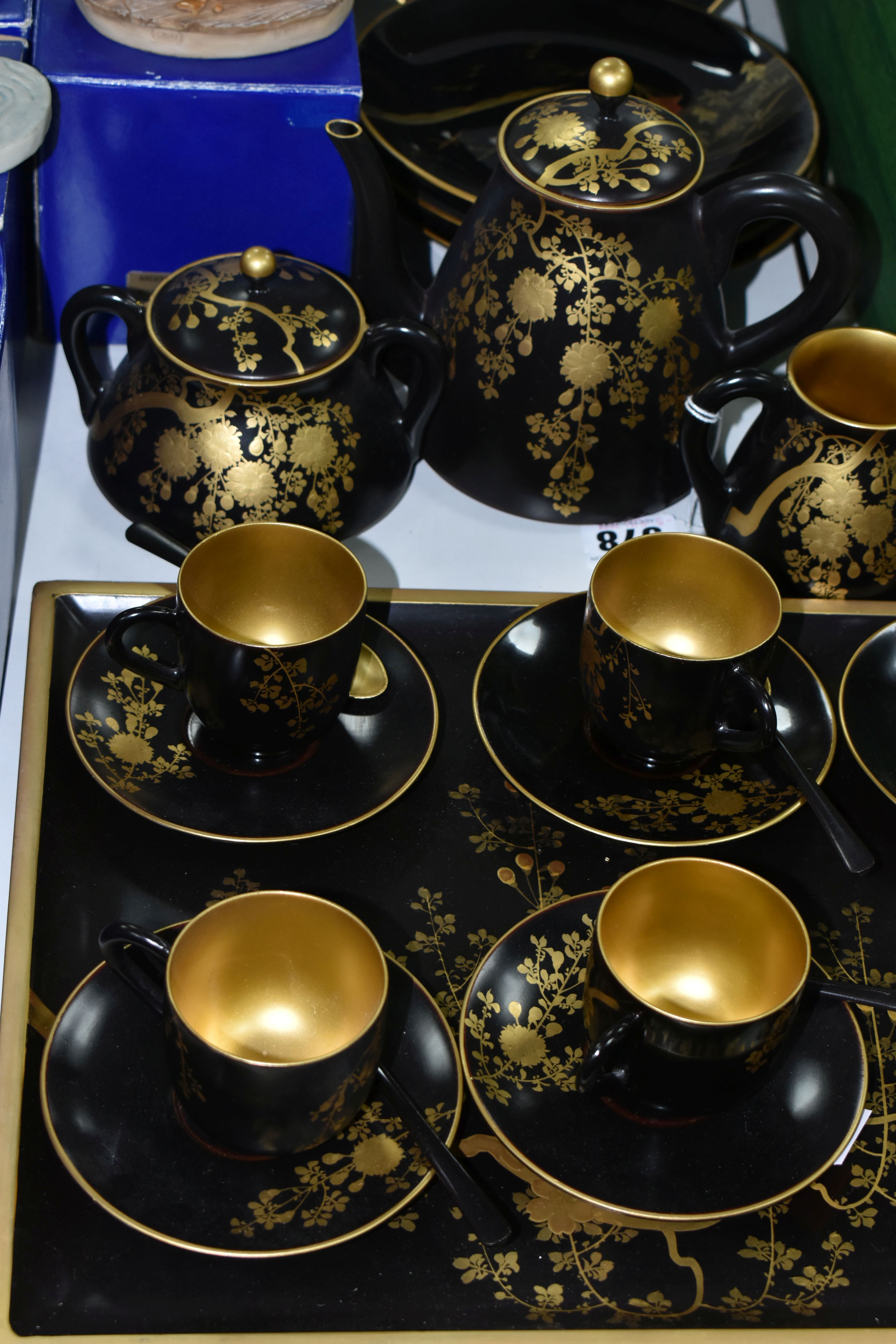 A CHINESE LACQUER WARE TEASET, comprising of a tray, six cups, saucers and spoons, teapot, milk