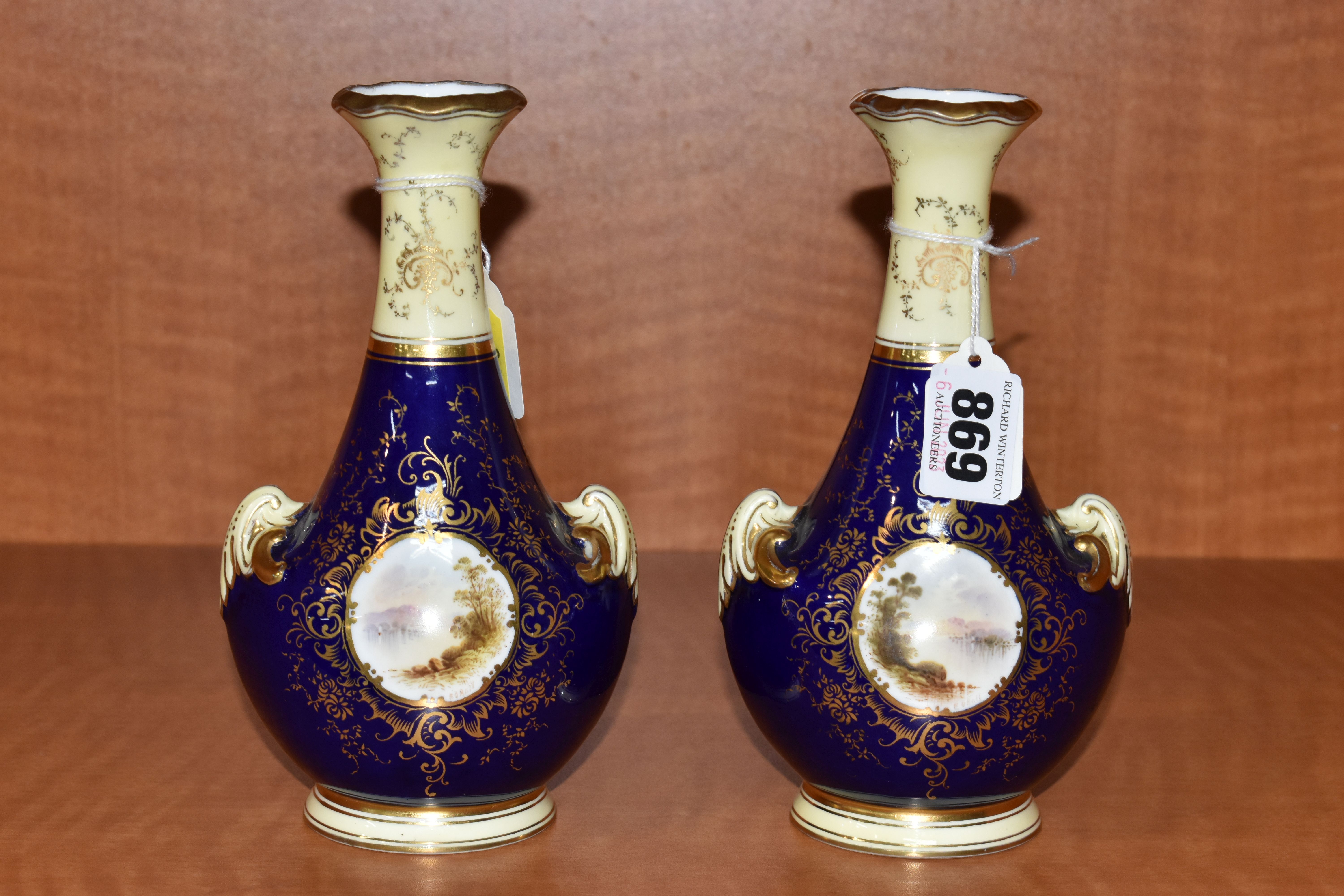 A PAIR OF EARLY 20TH CENTURY COALPORT BALUSTER VASES, blue, pale yellow and gilt ground, each hand