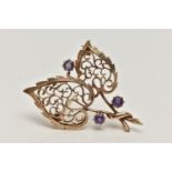 A 9CT GOLD, AMETHYST BROOCH, in the form of two open work leaves, set with three circular cut