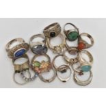 AN ASSORTMENT OF WHITE METAL RINGS, seventeen rings and a circular pendant, some stamped 925,