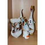 FOUR HUNGARIAN HOLLOHAZA PORCELAIN FIGURES, decorated in a fishnet design, harlequin pattern and