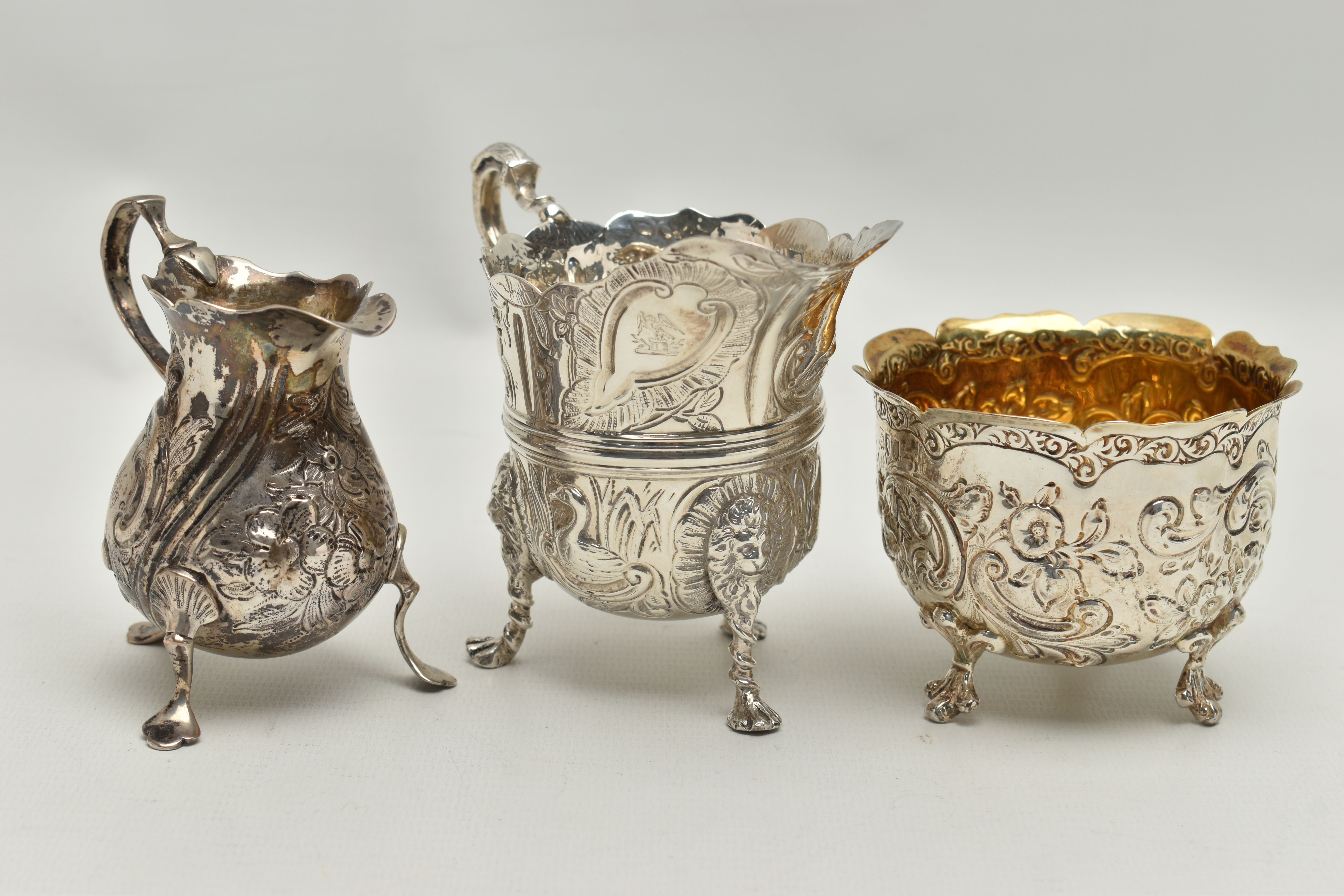 THREE PIECES OF SILVER, to include a George II creamer, embossed floral pattern with engraved