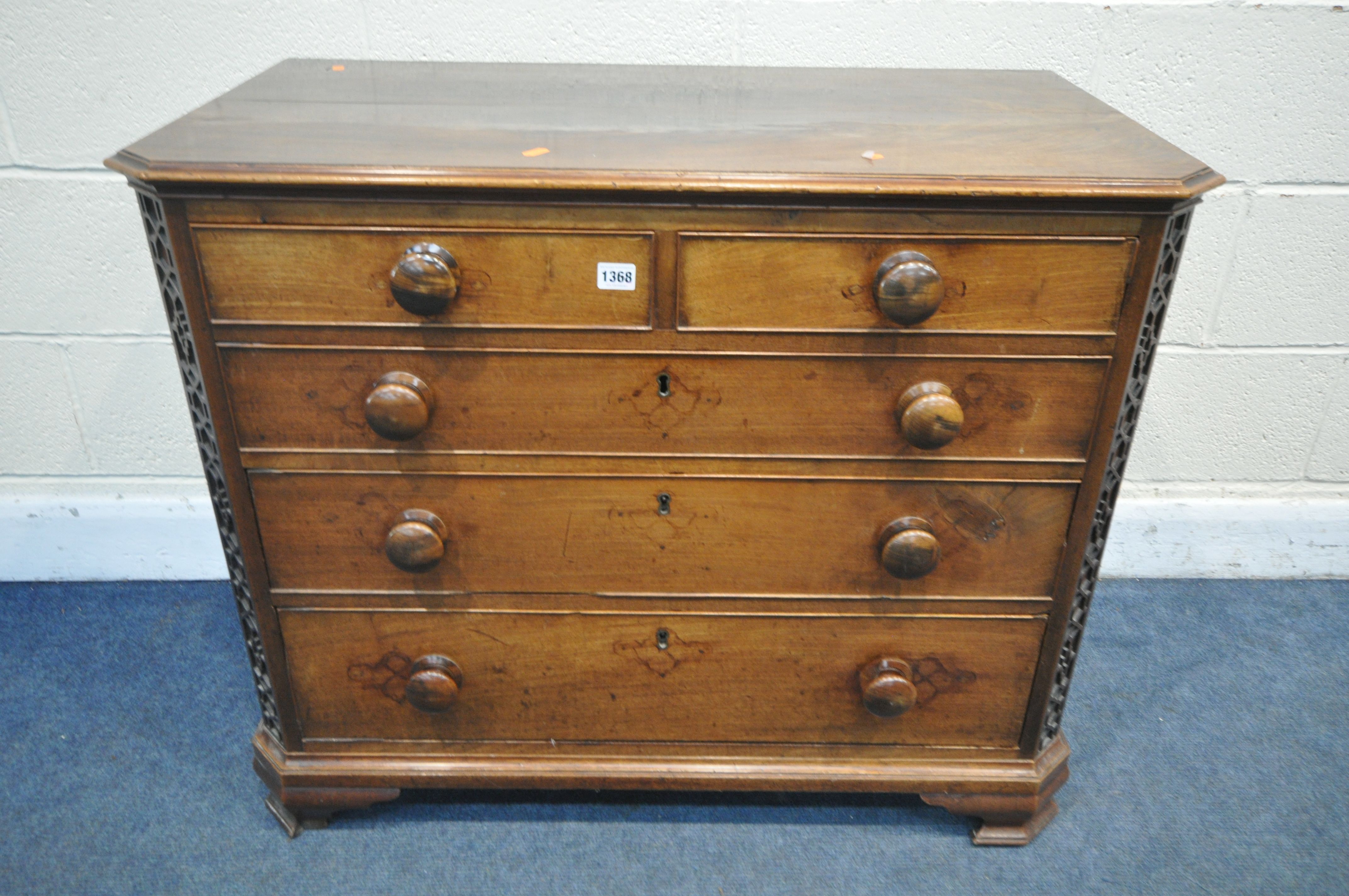 A GEORGIAN WALNUT CHEST OF TWO SHORT OVER THREE LONG GRADUATED DRAWERS, the canted front corners