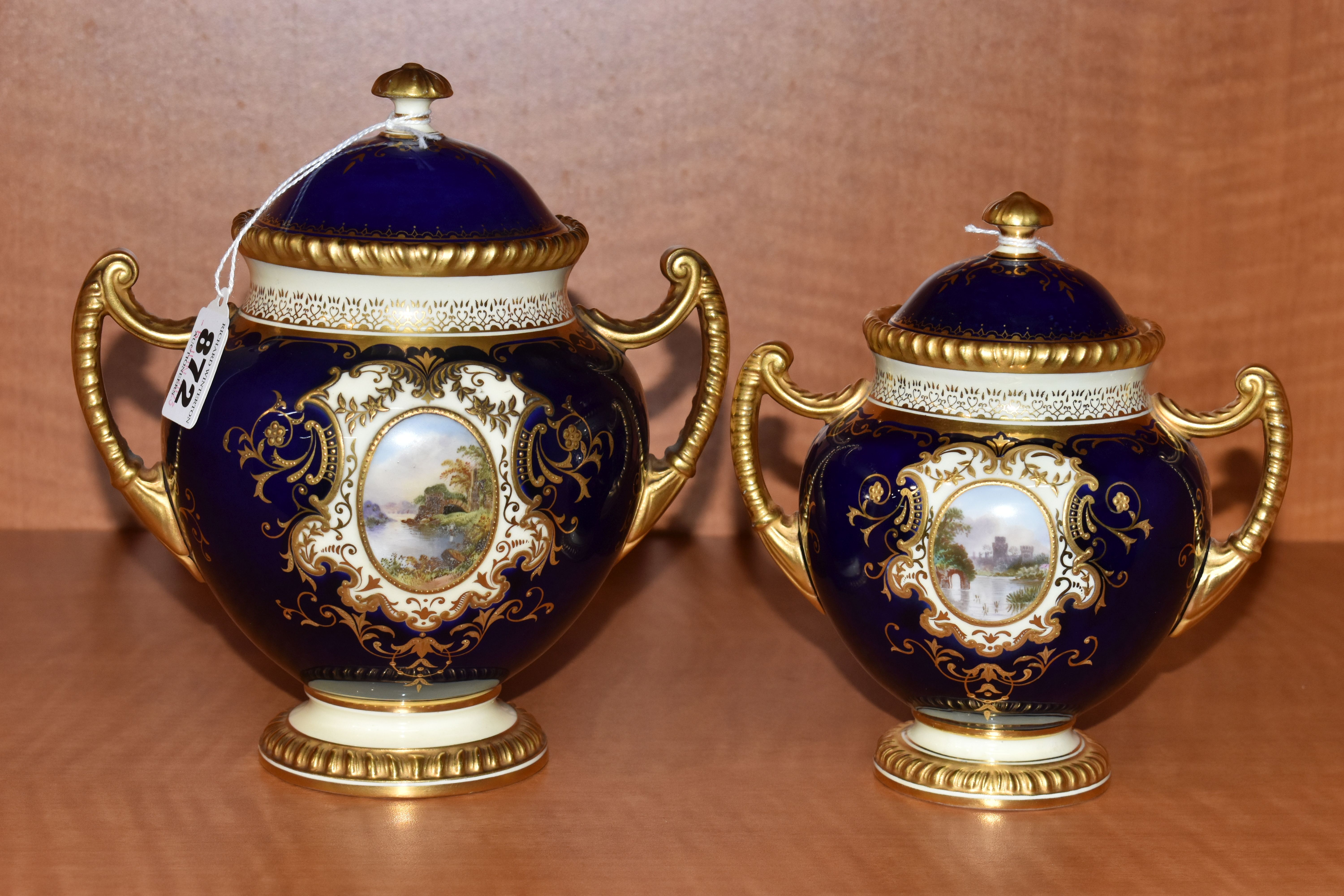 TWO EARLY 20TH CENTURY COALPORT TWIN HANDLED VASES AND COVERS, blue, pale yellow and gilt ground,