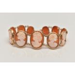 A 9CT GOLD, CAMEO BRACELET, designed as a series of eleven oval carved shell cameos, each