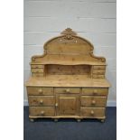 A VICTORIAN PINE SIDEBOARD, with a raised back, arrangement of drawers and single door, on turned