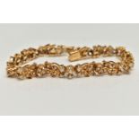 AN 18CT GOLD DIAMOND SET BRACELET, articulated floral bracelet set with round brilliant cut