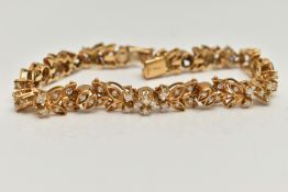 AN 18CT GOLD DIAMOND SET BRACELET, articulated floral bracelet set with round brilliant cut